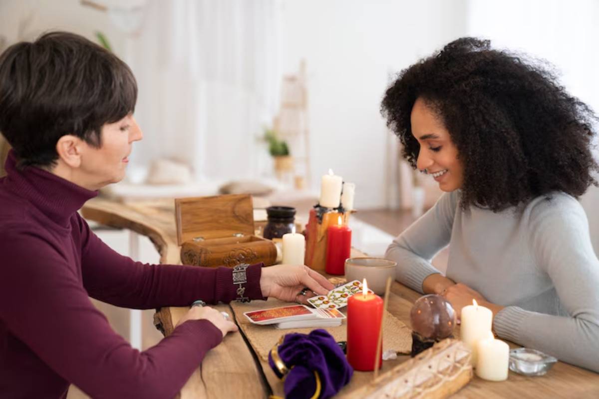 Two individuals engage in a tarot reading session, surrounded by candles, crystals, and a mystical ambiance.