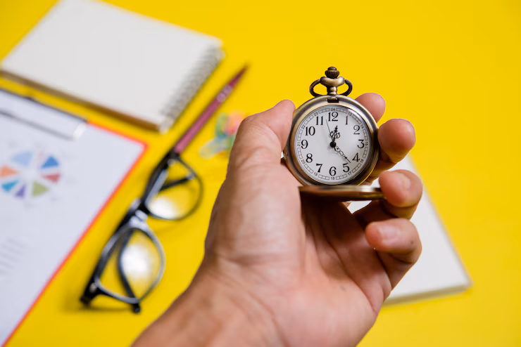 close up of a hand holding clock