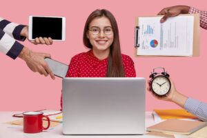 woman in red shirt with opened laptop