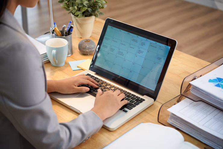 person planning monthlhy tasks on his laptop